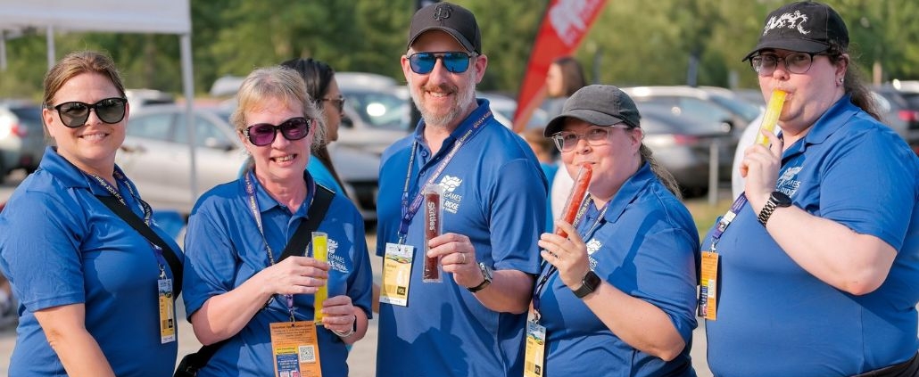 Five volunteers hold up freezies at the 2024 BC Summer Games