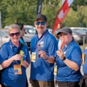 Five volunteers hold up freezies at the 2024 BC Summer Games