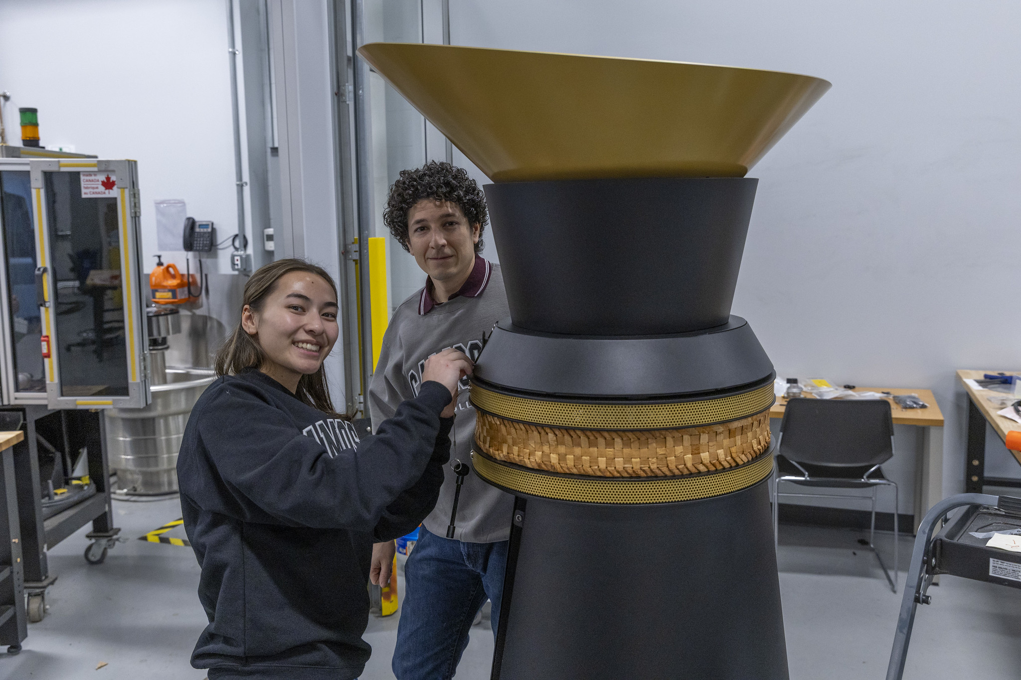 Mechanical Engineering Technology graduates Jesus Ponce de Leon and Julianna Kwan work on a cauldron initially developed and prototyped by students using applied learning and research practices.
