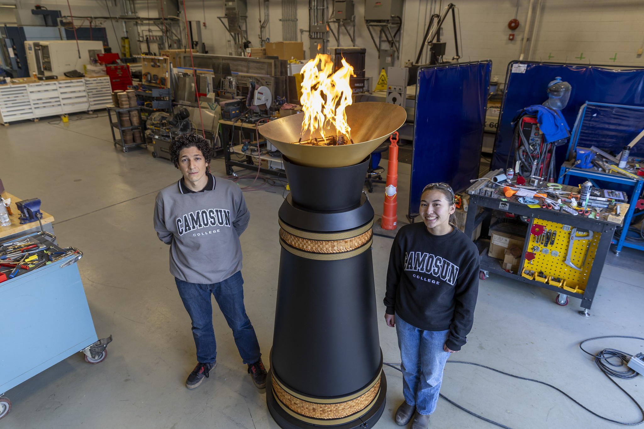 Mechanical Engineering Technology graduates Jesus Ponce de Leon and Julianna Kwan work on a cauldron initially developed and prototyped by students using applied learning and research practices.