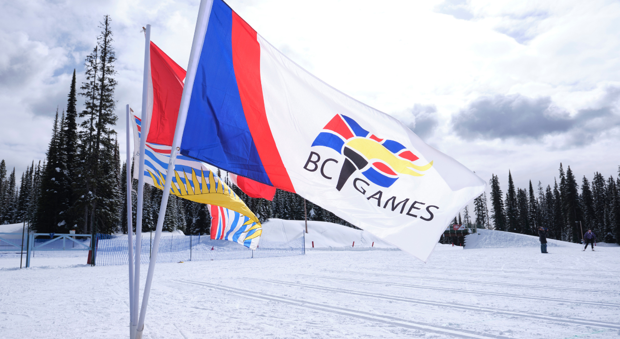 BC Games flag flying on ski hill.