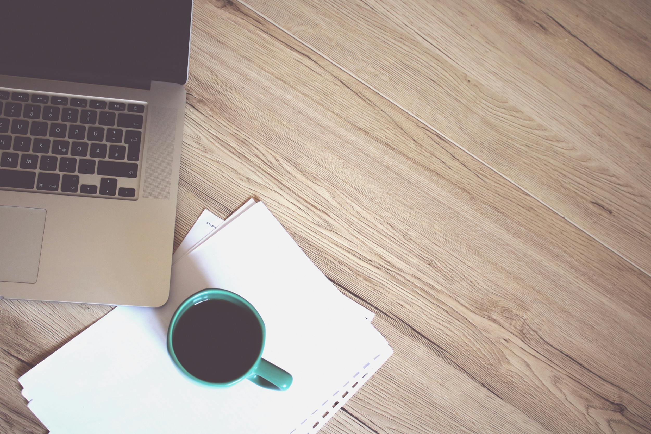 Gray Laptop Computer Beside Green Ceramic Mug